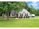 Charming single-story home with a well-maintained lawn and inviting curb appeal and exterior storage at 4524 Sugar Maple Rd, Oxford, NC 27565