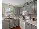 Bright kitchen featuring white appliances, neutral countertops, and plenty of cabinet storage at 4524 Sugar Maple Rd, Oxford, NC 27565