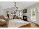 Cozy living room featuring a fireplace, neutral decor, and a ceiling fan for added comfort at 4524 Sugar Maple Rd, Oxford, NC 27565