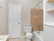 Bathroom featuring tile accents in the shower/bath and shelving to the right at 4724 Ludwell Branch Ct, Raleigh, NC 27612