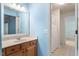 Bathroom with a single sink wooden vanity and a view of an adjacent bathroom at 4724 Ludwell Branch Ct, Raleigh, NC 27612