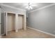 Bedroom with tile flooring and double closets provides ample storage at 4724 Ludwell Branch Ct, Raleigh, NC 27612