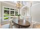 Dining room with large windows, designer lighting, and an elegant doorway leading to the outside at 4724 Ludwell Branch Ct, Raleigh, NC 27612