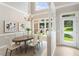 Bright dining area with natural light, stylish chandelier, and an adjacent door to the outside at 4724 Ludwell Branch Ct, Raleigh, NC 27612