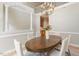 Elegant dining room with stylish chandelier, view of the open floor plan, and lovely trim at 4724 Ludwell Branch Ct, Raleigh, NC 27612