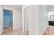 Hallway featuring neutral walls and trim connecting to a bedroom and bathroom, offering smooth transition at 4724 Ludwell Branch Ct, Raleigh, NC 27612