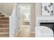 Hallway with stairway, open doorway, and a glimpse of a bedroom at 4724 Ludwell Branch Ct, Raleigh, NC 27612