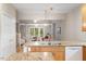Kitchen with a view to the living room and natural light streaming through the windows at 4724 Ludwell Branch Ct, Raleigh, NC 27612