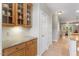 Butlers pantry area in kitchen with granite counters, built in cabinets, and direct access to other areas at 4724 Ludwell Branch Ct, Raleigh, NC 27612