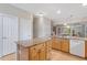 Kitchen featuring a granite island, wooden cabinets, and a seamless transition to the living area at 4724 Ludwell Branch Ct, Raleigh, NC 27612