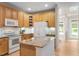 Well-lit kitchen with white appliances, granite countertops, wooden cabinets, and a central island at 4724 Ludwell Branch Ct, Raleigh, NC 27612