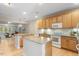 Open kitchen with granite countertops, center island, white appliances, and view to living room at 4724 Ludwell Branch Ct, Raleigh, NC 27612