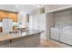 Open kitchen with island, granite countertops, and laundry area at 4724 Ludwell Branch Ct, Raleigh, NC 27612