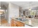 Kitchen showcasing a seamless transition to the living area with a granite countertop and modern faucet at 4724 Ludwell Branch Ct, Raleigh, NC 27612