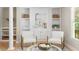 Brightly lit living room with built-in shelving and a cozy seating area at 4724 Ludwell Branch Ct, Raleigh, NC 27612