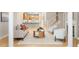 Spacious living room featuring modern furniture, a central table, and open staircase at 4724 Ludwell Branch Ct, Raleigh, NC 27612