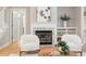 Comfortable living room highlighting a fireplace with a marble surround and a white mantel at 4724 Ludwell Branch Ct, Raleigh, NC 27612