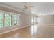 Bright and airy living room with large windows and neutral paint colors at 4724 Ludwell Branch Ct, Raleigh, NC 27612