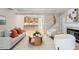 Bright living room with modern seating, open staircase, and view of the eat-in kitchen at 4724 Ludwell Branch Ct, Raleigh, NC 27612