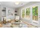 Inviting living room featuring custom shelving, a view to a deck, and lots of natural light at 4724 Ludwell Branch Ct, Raleigh, NC 27612