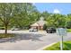 Well-maintained parking area near the community center surrounded by mature trees and green space at 4724 Ludwell Branch Ct, Raleigh, NC 27612