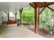Relaxing outdoor patio area with swing and views of the landscaped yard at 4724 Ludwell Branch Ct, Raleigh, NC 27612