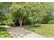 Tranquil walking path through a lush, green area with mature trees and a charming bench at 4724 Ludwell Branch Ct, Raleigh, NC 27612