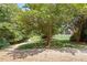 Scenic walking path leading toward a community pool nestled among lush trees and greenery at 4724 Ludwell Branch Ct, Raleigh, NC 27612