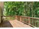 Large wooden deck surrounded by mature trees, providing a private outdoor space at 4724 Ludwell Branch Ct, Raleigh, NC 27612