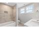 Bathroom with tiled shower, built-in niche, and bright natural light at 4896 Grosbeak Ct, Mebane, NC 27302