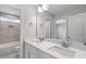 Bright bathroom featuring a double vanity with white countertop and walk-in shower at 4896 Grosbeak Ct, Mebane, NC 27302