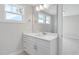 Bright bathroom vanity with white cabinets, countertop, and a large mirror at 4896 Grosbeak Ct, Mebane, NC 27302
