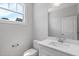 Clean, modern bathroom featuring a white vanity with a quartz countertop and chrome fixtures at 4896 Grosbeak Ct, Mebane, NC 27302