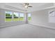 Spacious bedroom featuring carpet, neutral paint, ceiling fan, tray ceiling and ample natural light at 4896 Grosbeak Ct, Mebane, NC 27302