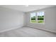 Bright bedroom with carpet, natural light, and views of the community at 4896 Grosbeak Ct, Mebane, NC 27302