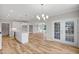Bright, open kitchen featuring white cabinets, stainless steel appliances, and an island with a sink and quartz countertop at 4896 Grosbeak Ct, Mebane, NC 27302