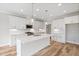 Modern kitchen with white cabinets, quartz countertops, stainless steel appliances, and pendant lighting at 4896 Grosbeak Ct, Mebane, NC 27302