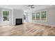 Spacious living room features hardwood floors, a fireplace, and multiple windows for ample natural light at 4896 Grosbeak Ct, Mebane, NC 27302