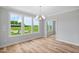 Bright and airy living room with large windows offering scenic views and a modern chandelier at 4896 Grosbeak Ct, Mebane, NC 27302