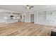 Expansive living area with hardwood floors, built-in shelving, and an open layout leading to a modern kitchen at 4896 Grosbeak Ct, Mebane, NC 27302