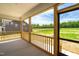 Screened-in porch showcasing natural wood railing with a scenic backyard view at 4896 Grosbeak Ct, Mebane, NC 27302