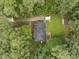 Aerial shot of the property showcasing the house, driveway and surrounding trees at 5109 Makena Dr, Raleigh, NC 27615