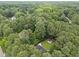 High angle aerial view of home surrounded by lush, mature trees at 5109 Makena Dr, Raleigh, NC 27615