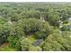 An aerial perspective shows the home nestled among a dense forest of trees at 5109 Makena Dr, Raleigh, NC 27615