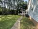 Backyard featuring a well-maintained lawn with a view of the back of the home and surrounding trees at 5109 Makena Dr, Raleigh, NC 27615