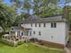 A deck and white siding highlight this spacious backyard surrounded by mature trees at 5109 Makena Dr, Raleigh, NC 27615