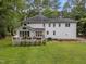 A deck and white siding highlight this spacious backyard surrounded by mature trees at 5109 Makena Dr, Raleigh, NC 27615