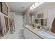 Well-lit bathroom boasting double sinks, granite countertops, and a shower-tub combo with decorative shower curtain at 5109 Makena Dr, Raleigh, NC 27615