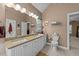 Bright bathroom featuring double sinks, granite countertops, and a separate toilet area for added privacy at 5109 Makena Dr, Raleigh, NC 27615