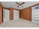 Comfortable bedroom featuring a closet, neutral carpet, and an orange accent wall, creating a warm and inviting space at 5109 Makena Dr, Raleigh, NC 27615